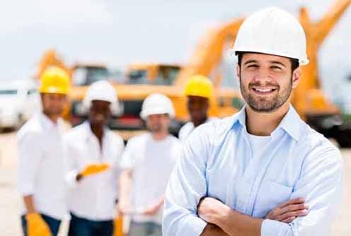 Contractors stand in front of a construction project 